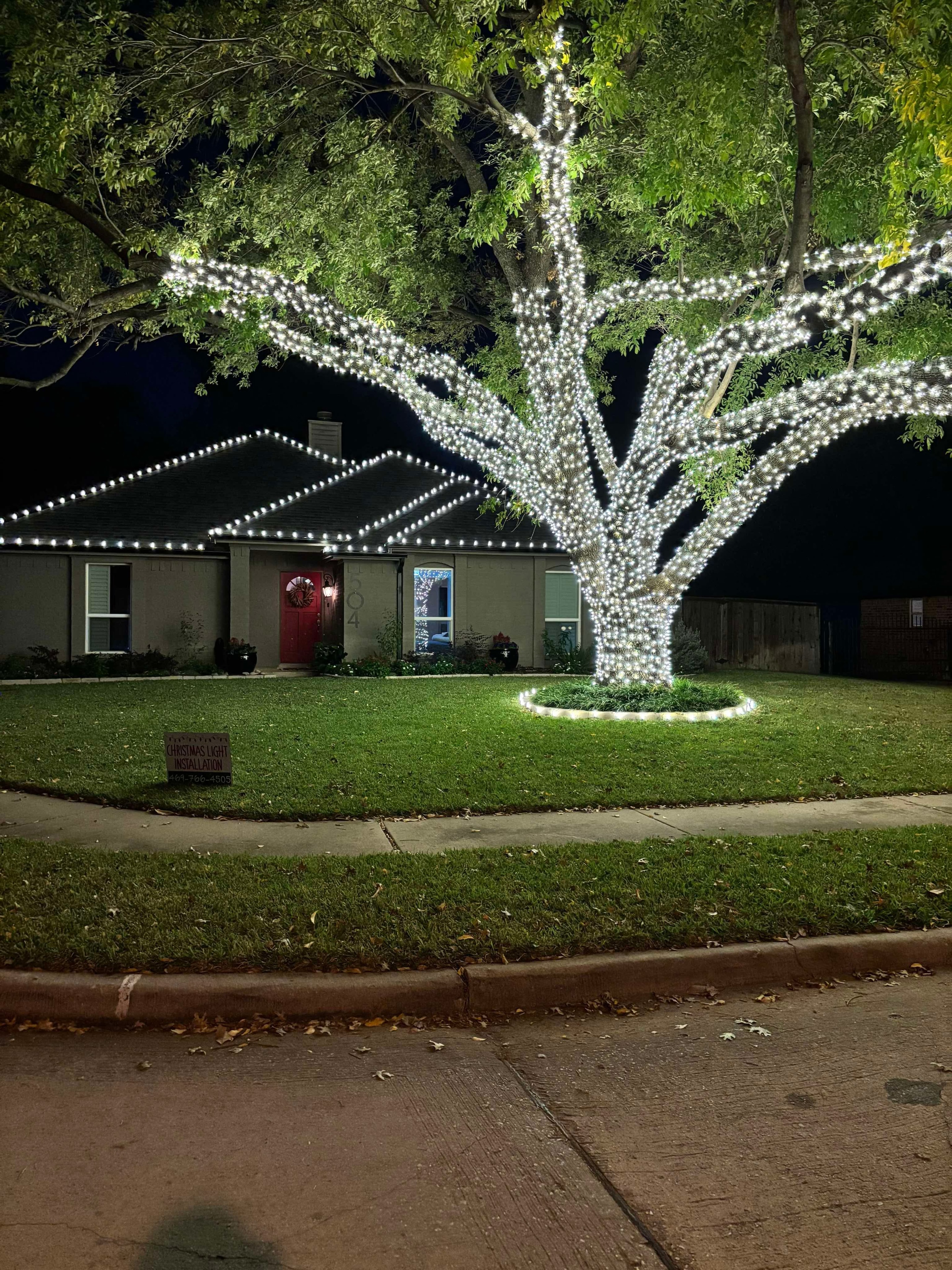 Home with tree wrapped in white Christmas lights